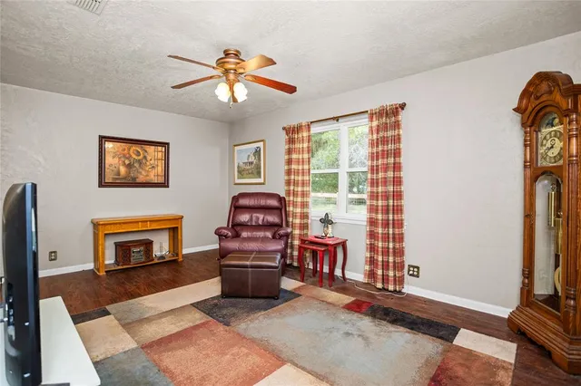 a living room with furniture a window and a flat screen tv