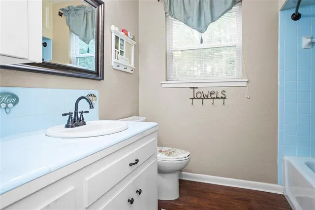 a bathroom with a sink a mirror and a toilet