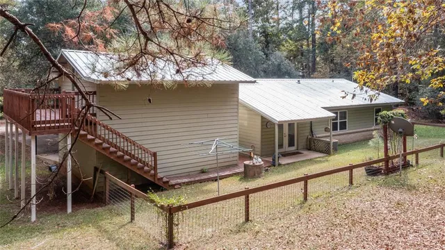 a view of a house with a yard and sitting area
