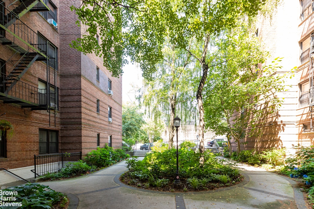 3840 Greystone Avenue, Unit 5L Bronx, NY 10463 - Photo 19 of 41 a view of a house with a tree and plants