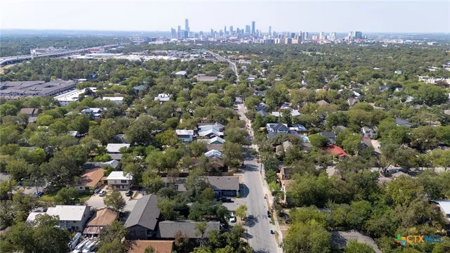 an aerial view of town with residential houses with outdoor space and trees