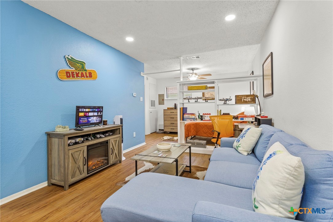 4701 Red River Street, Unit 102 Austin, TX 78751 - Photo 2 of 20 a living room with furniture and a fireplace