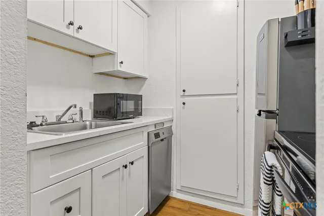 a kitchen with a sink and a refrigerator