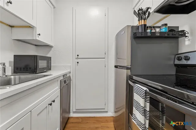 a kitchen with a sink and cabinets