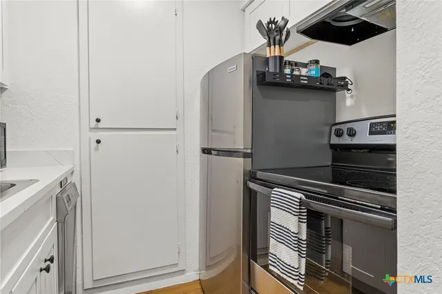 a close view of stove and refrigerator