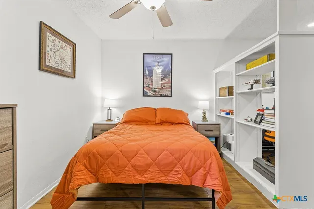 a bed sitting in a bedroom next to a window