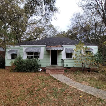 a front view of a house with a yard and a garage