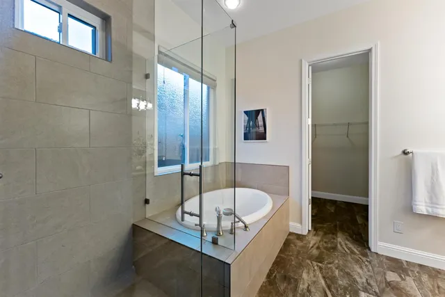 a bathroom with a tub and shower