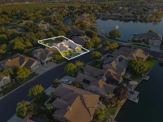 an aerial view of a house with a lake view