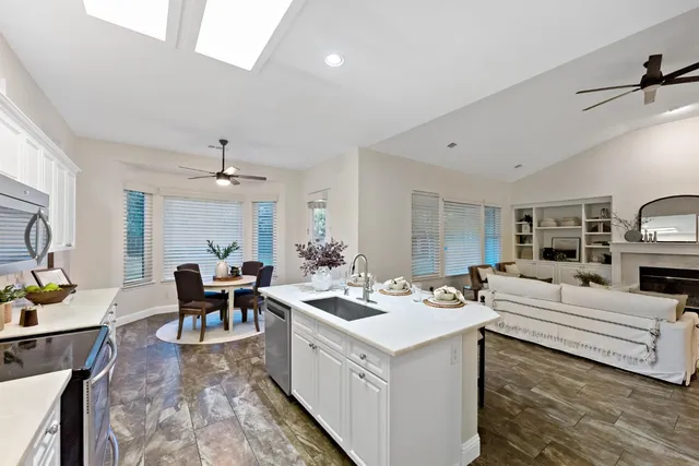 a kitchen with a sink stove and view living room