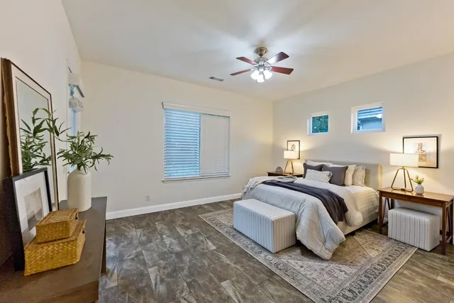 a spacious bedroom with a bed and a window