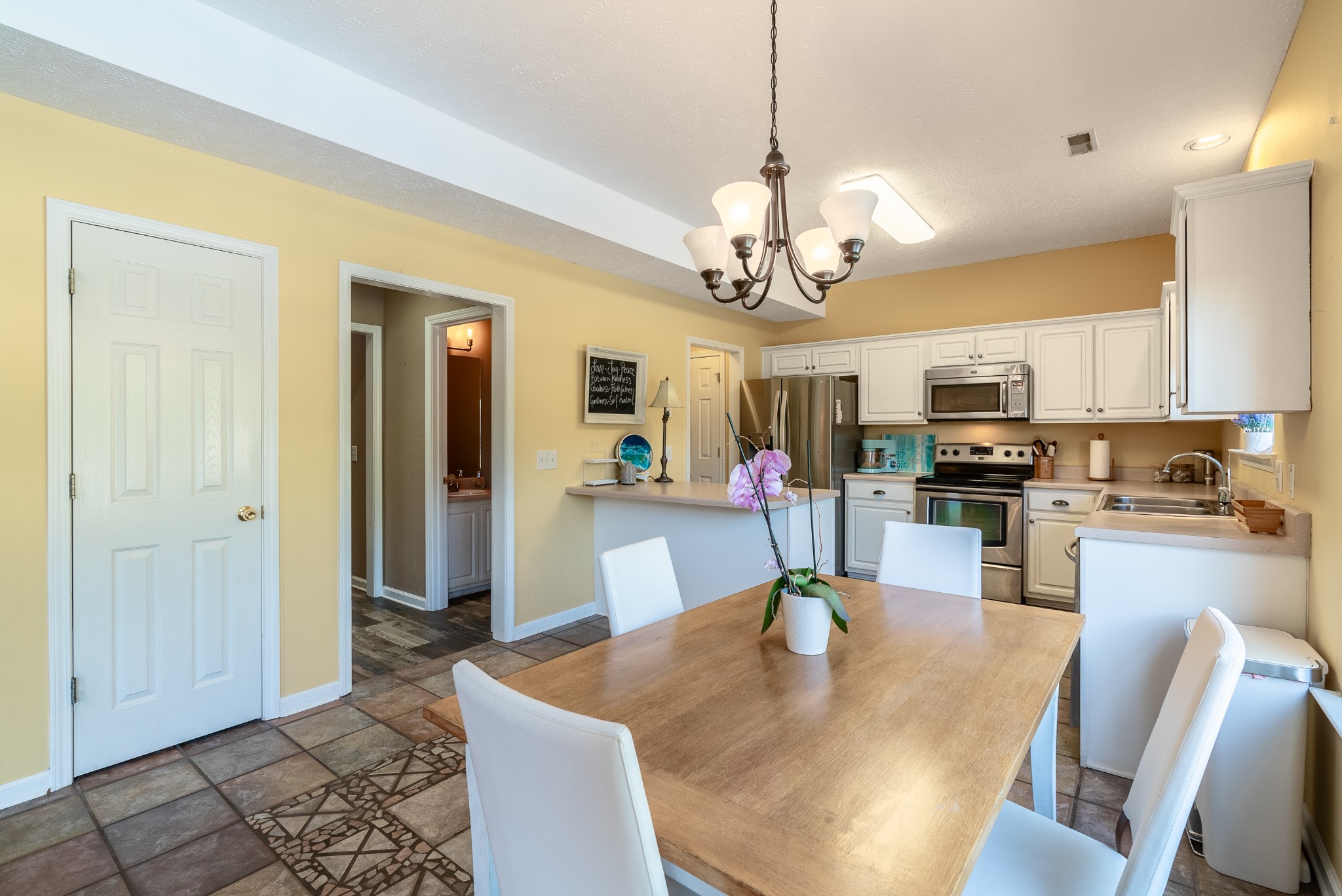 1707 Ginger Way Spring Hill, TN 37174 - Photo 13 of 39 a view of a dining room and livingroom with furniture wooden floor a chandelier