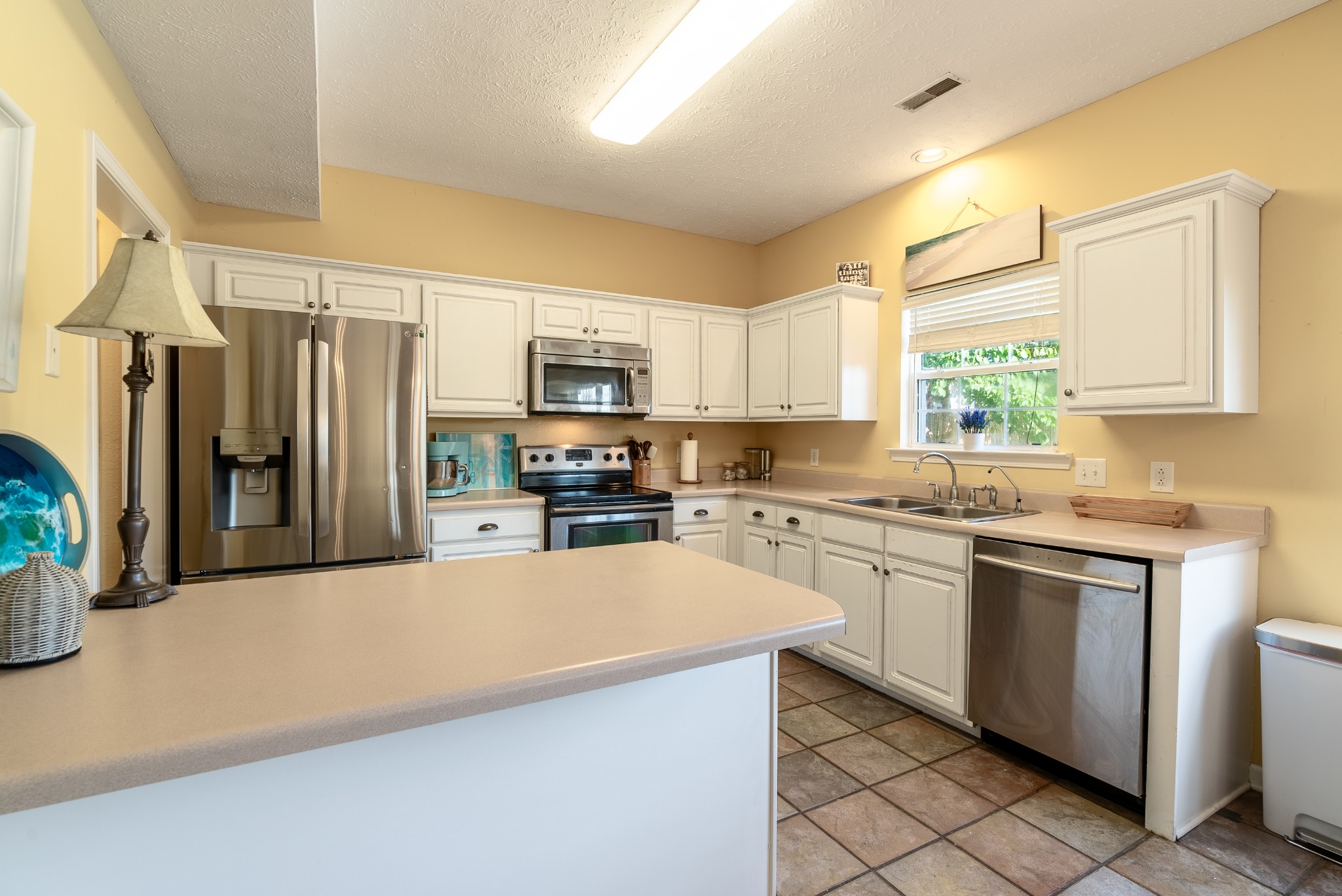 1707 Ginger Way Spring Hill, TN 37174 - Photo 14 of 39 a kitchen with stainless steel appliances a refrigerator sink and microwave