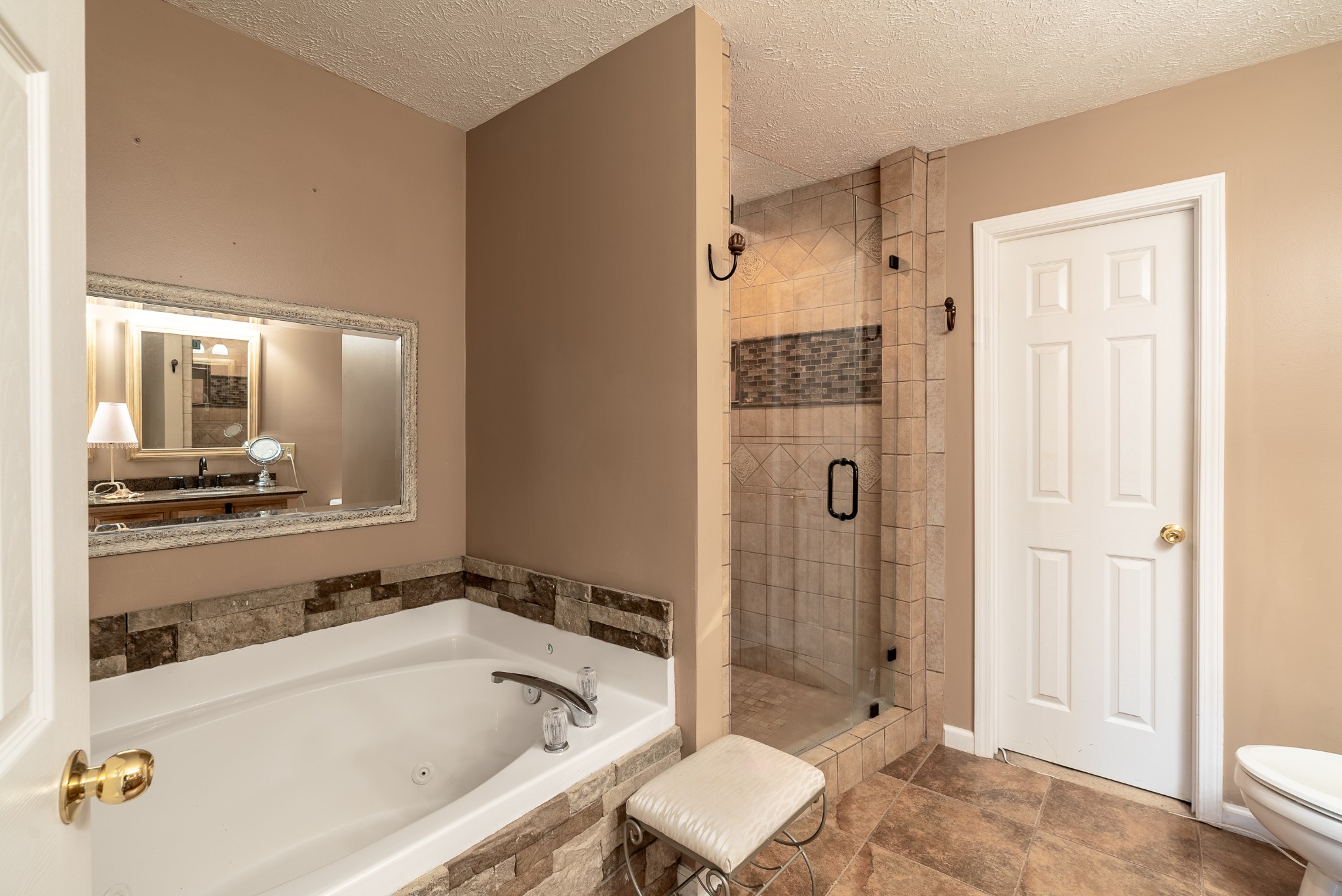 1707 Ginger Way Spring Hill, TN 37174 - Photo 23 of 39 a bathroom with a granite countertop tub shower and mirror