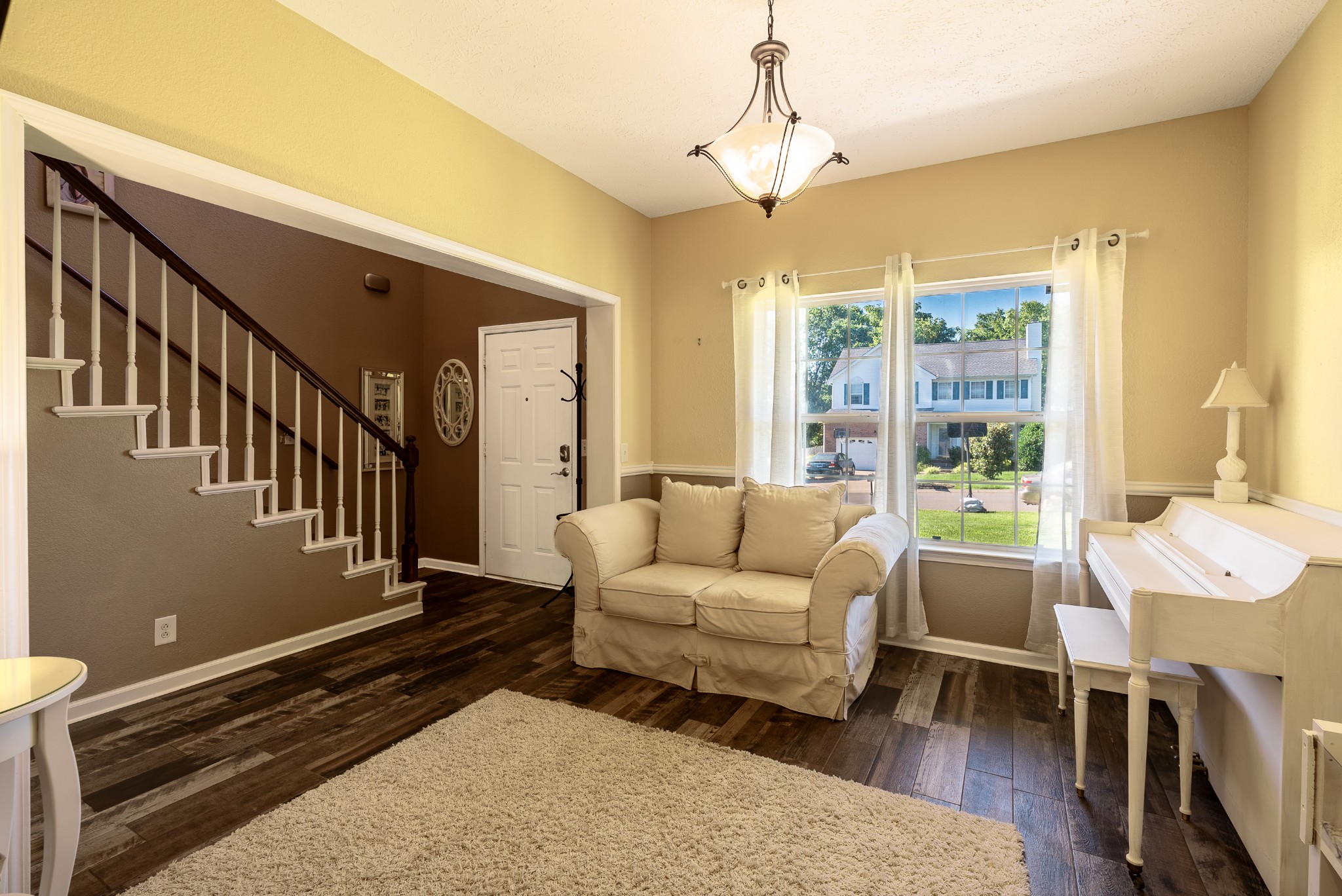 1707 Ginger Way Spring Hill, TN 37174 - Photo 3 of 39 a living room with furniture a chandelier and a dining table