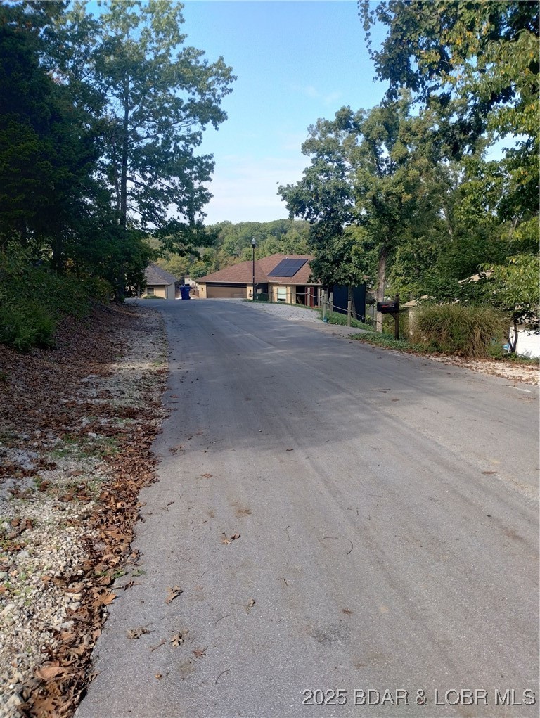 Lot 49 South Beacon Ridge Lake Ozark, MO 65049 - Photo 4 of 28 Subject street scene in front of home