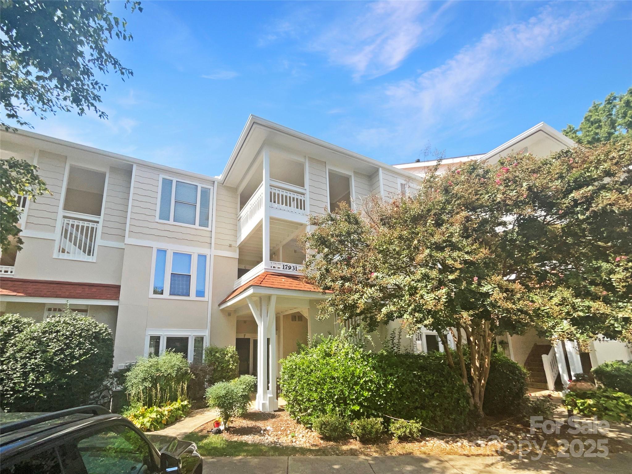 a front view of a house with trees