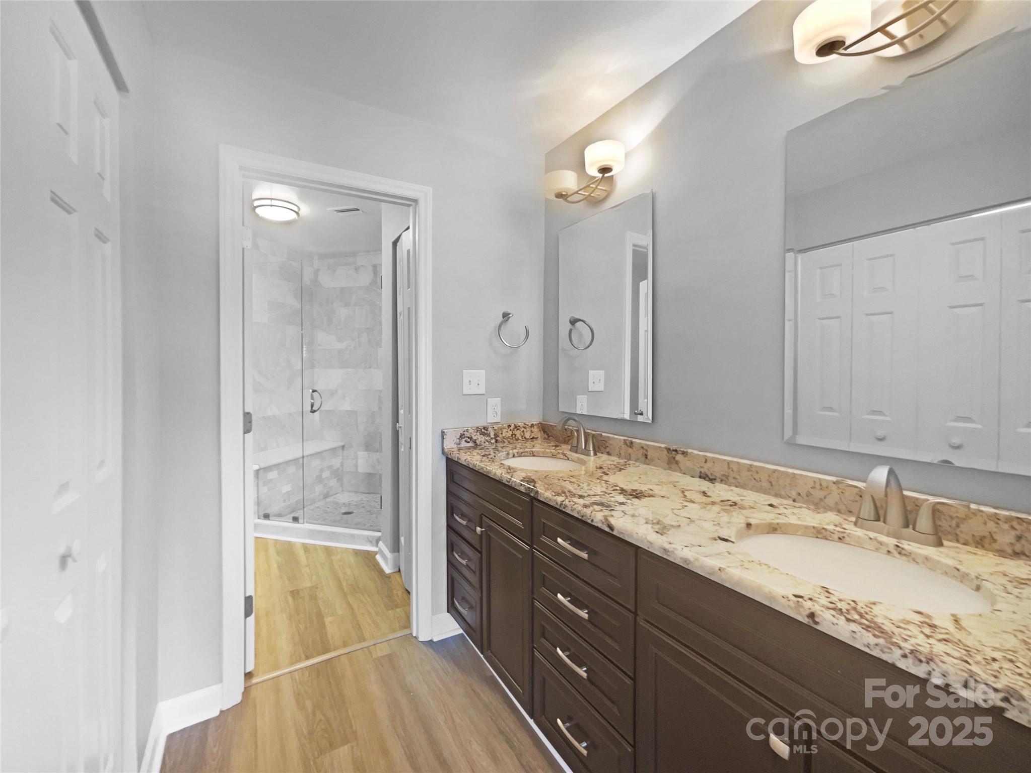 17931 Kings Point Drive, Unit G Cornelius, NC 28031 - Photo 12 of 20 a bathroom with a granite countertop sink mirror and