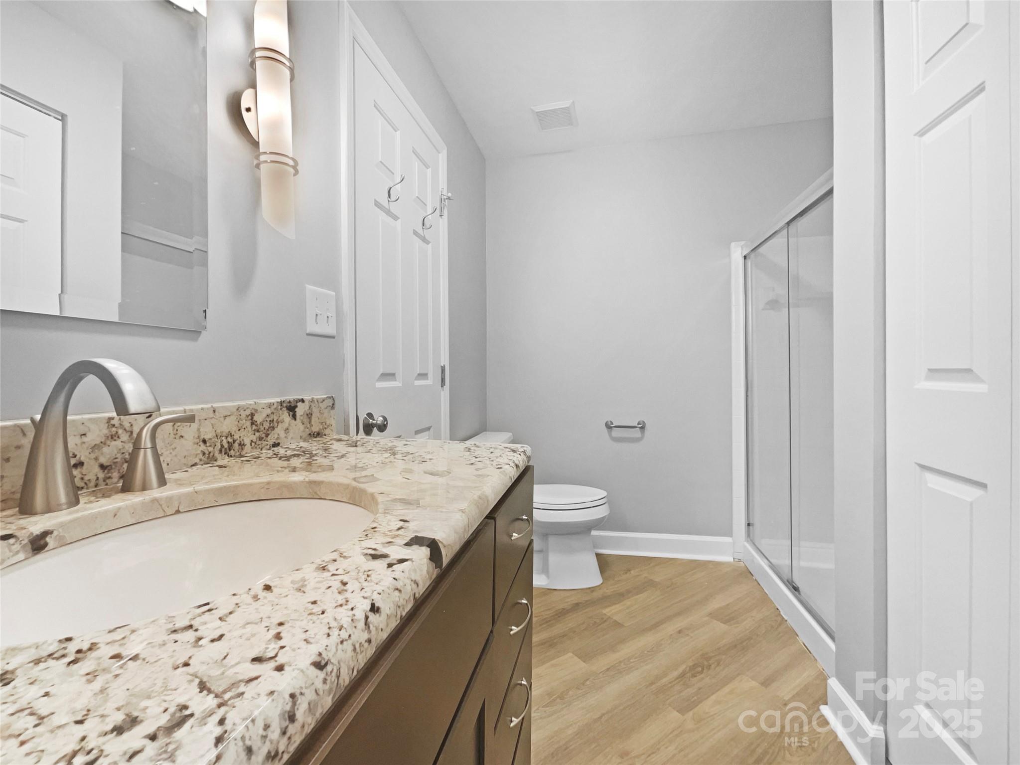 17931 Kings Point Drive, Unit G Cornelius, NC 28031 - Photo 17 of 20 a bathroom with a granite countertop sink and a mirror