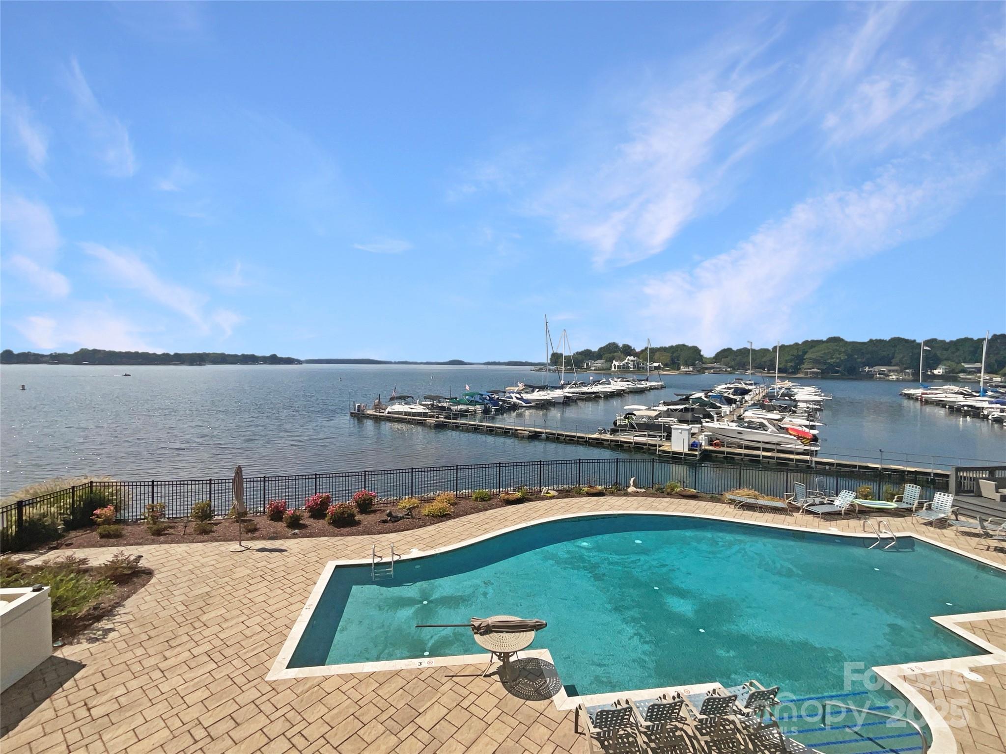 17931 Kings Point Drive, Unit G Cornelius, NC 28031 - Photo 18 of 20 a view of a swimming pool and an ocean view