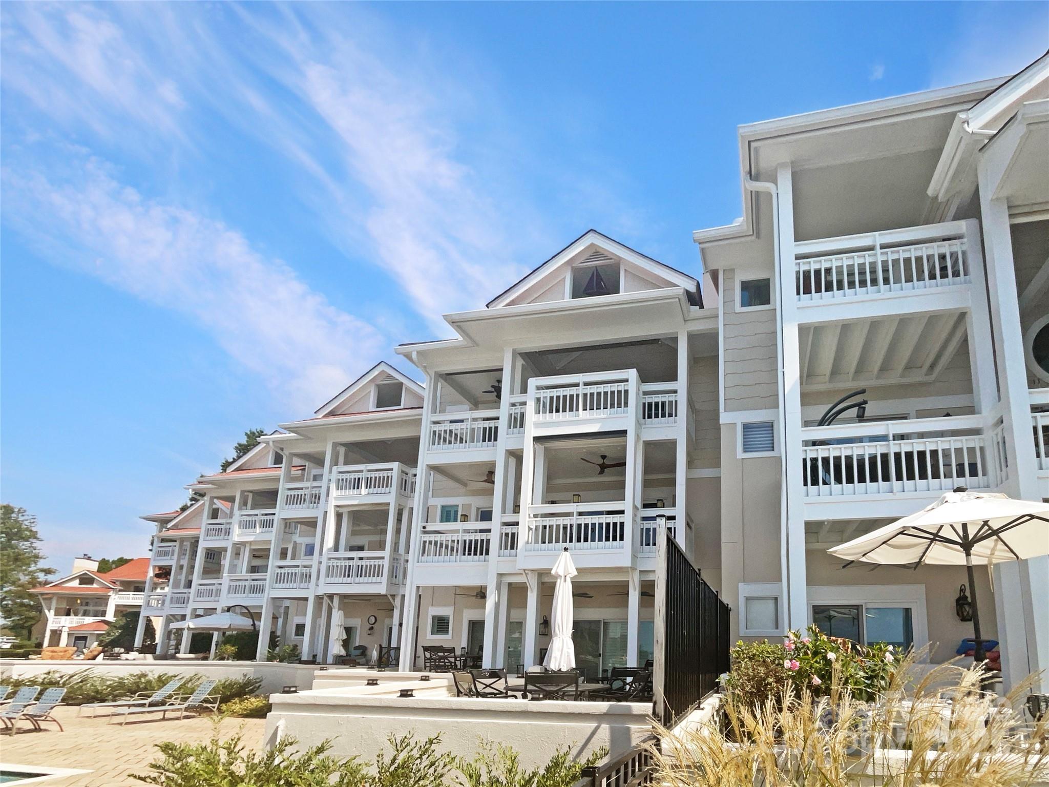 17931 Kings Point Drive, Unit G Cornelius, NC 28031 - Photo 20 of 20 a front view of a residential apartment building with a yard