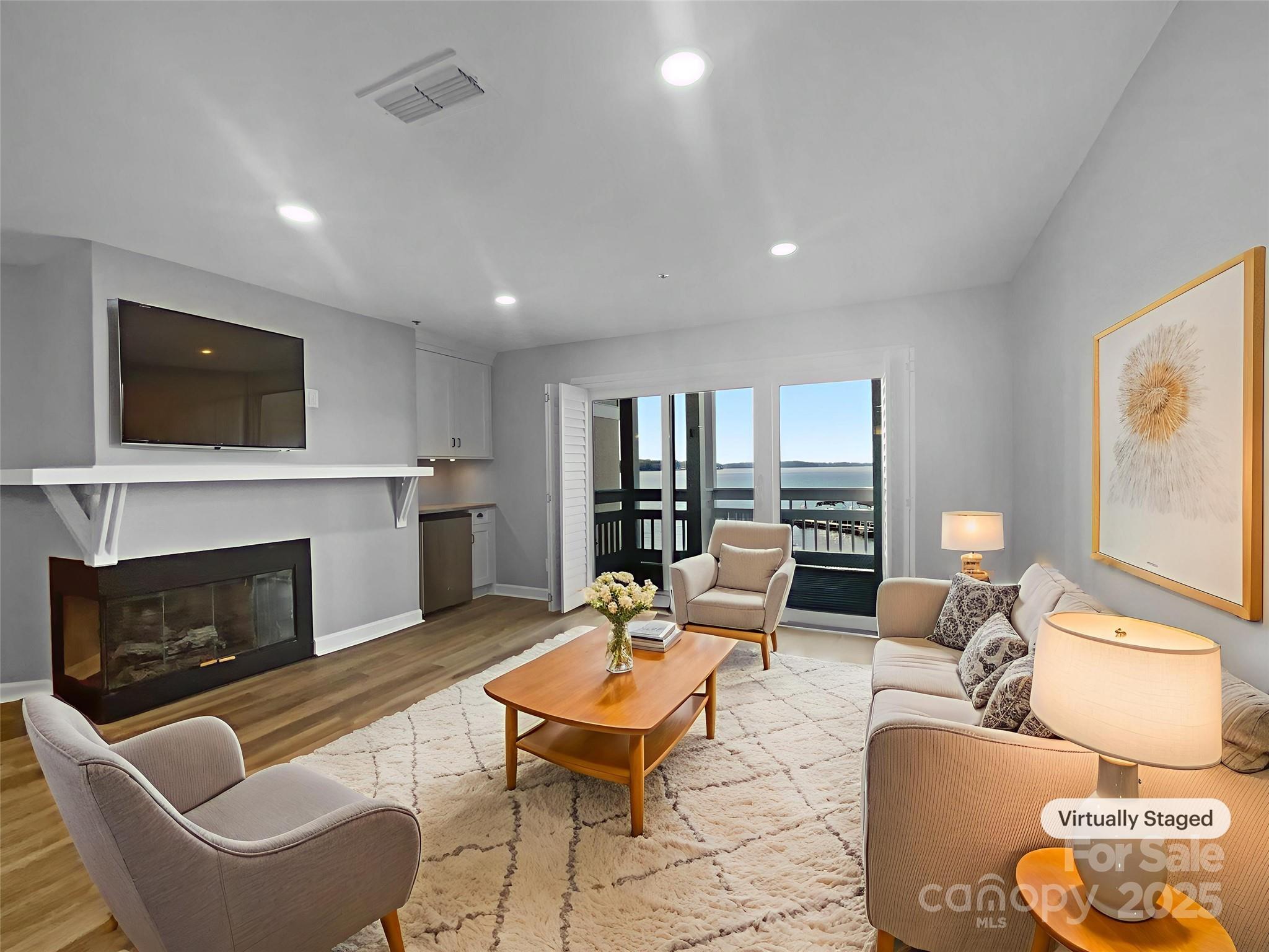 17931 Kings Point Drive, Unit G Cornelius, NC 28031 - Photo 3 of 20 a living room with furniture fireplace and flat screen tv