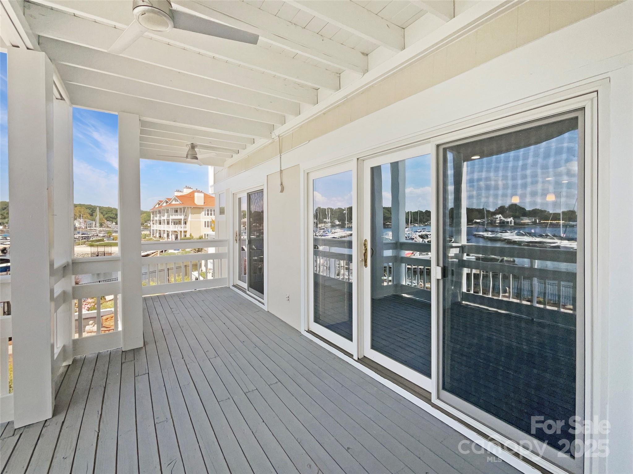 17931 Kings Point Drive, Unit G Cornelius, NC 28031 - Photo 6 of 20 a view of a hallway with wooden floor and door