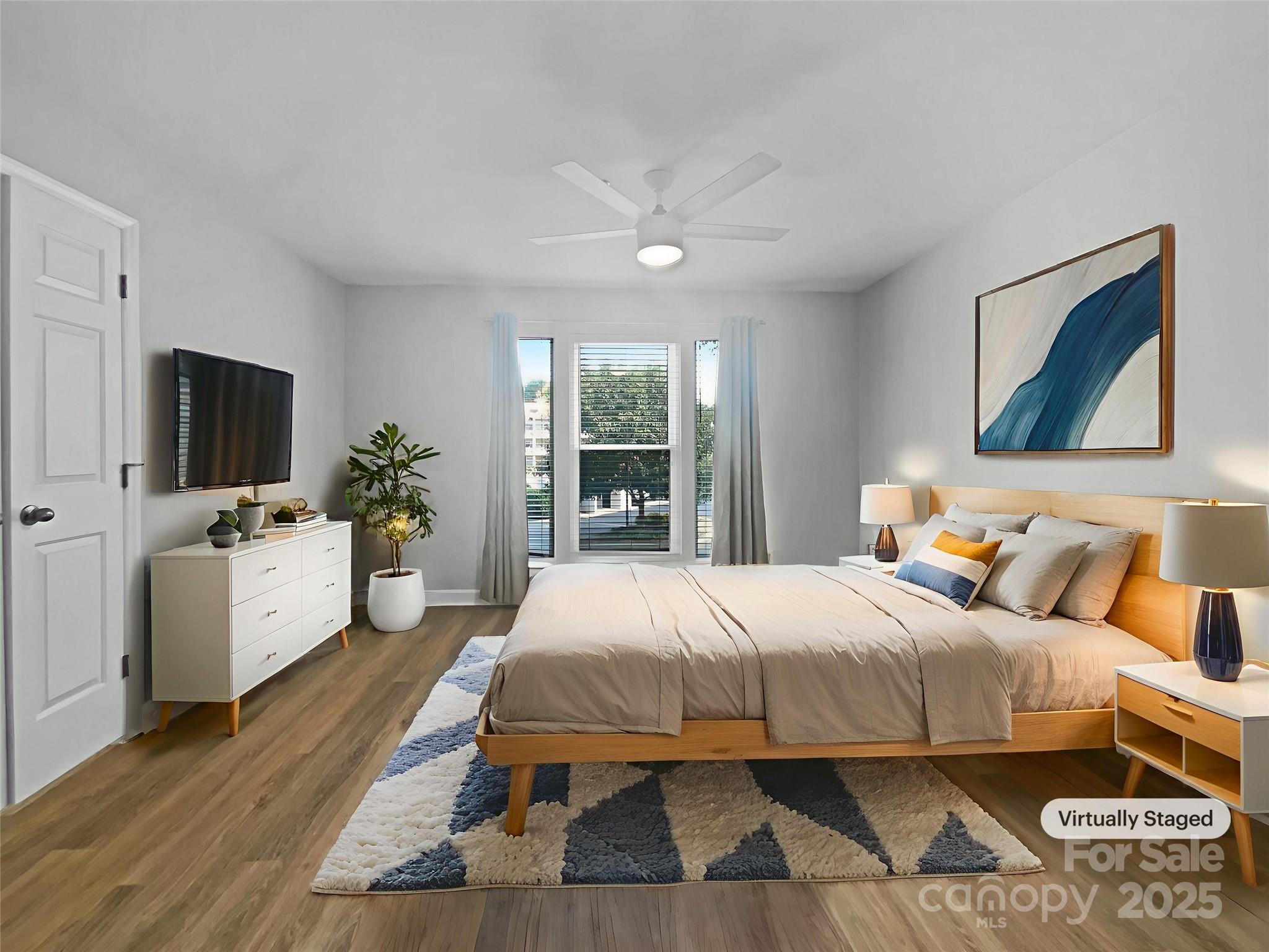 17931 Kings Point Drive, Unit G Cornelius, NC 28031 - Photo 10 of 20 a bedroom with a bed and a flat screen tv