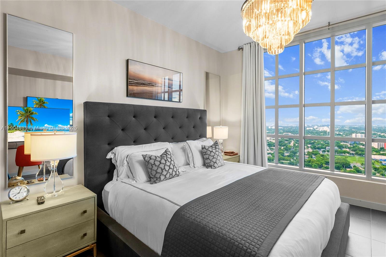 3301 Northeast 1st Avenue, Unit H2907 Miami, FL 33137 - Photo 11 of 29 a bedroom with a bed and a chandelier