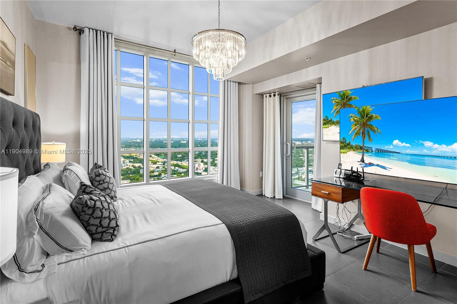 3301 Northeast 1st Avenue, Unit H2907 Miami, FL 33137 - Photo 10 of 29 a spacious bedroom with a bed a couch and a chandelier