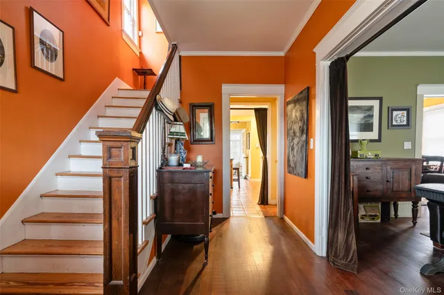 a view of entryway and hall with wooden floor