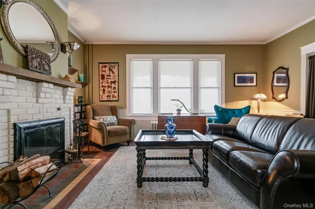 a living room with furniture fireplace and a large window