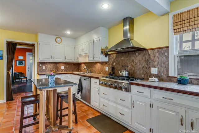 a kitchen with stainless steel appliances granite countertop a sink and cabinets