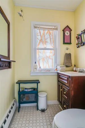 a bathroom with a toilet a sink and a window