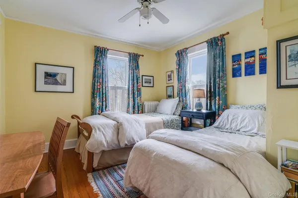 a bedroom with two beds and a chandelier