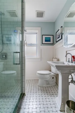 a bathroom with a sink toilet and shower