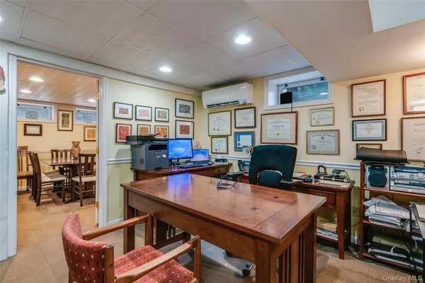 a living room with furniture a flat screen tv and a dining table