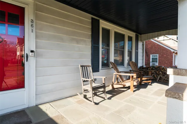 a building outdoor space with patio furniture and potted plants