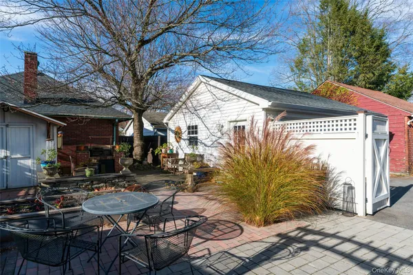 a view of a house with backyard outdoor seating and wooden fence