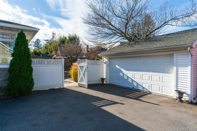 a view of a house with a yard and garage