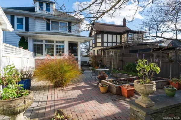 a view of a house with sitting area and potted plants