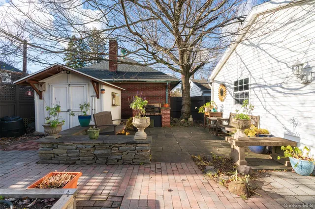 a view of a house with backyard and sitting area