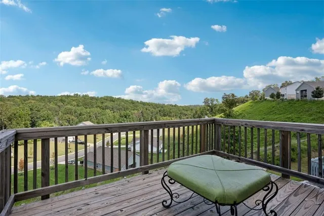 a view of a balcony with wooden floor chairs
