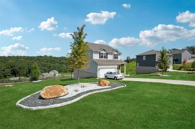 a view of a house with backyard and a slide