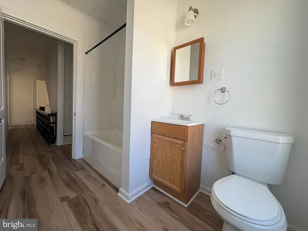 a white toilet sitting next to a bathroom sink
