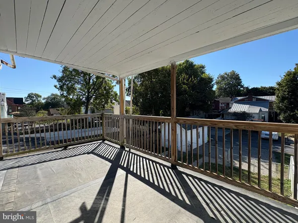 a balcony with view of trees in the background