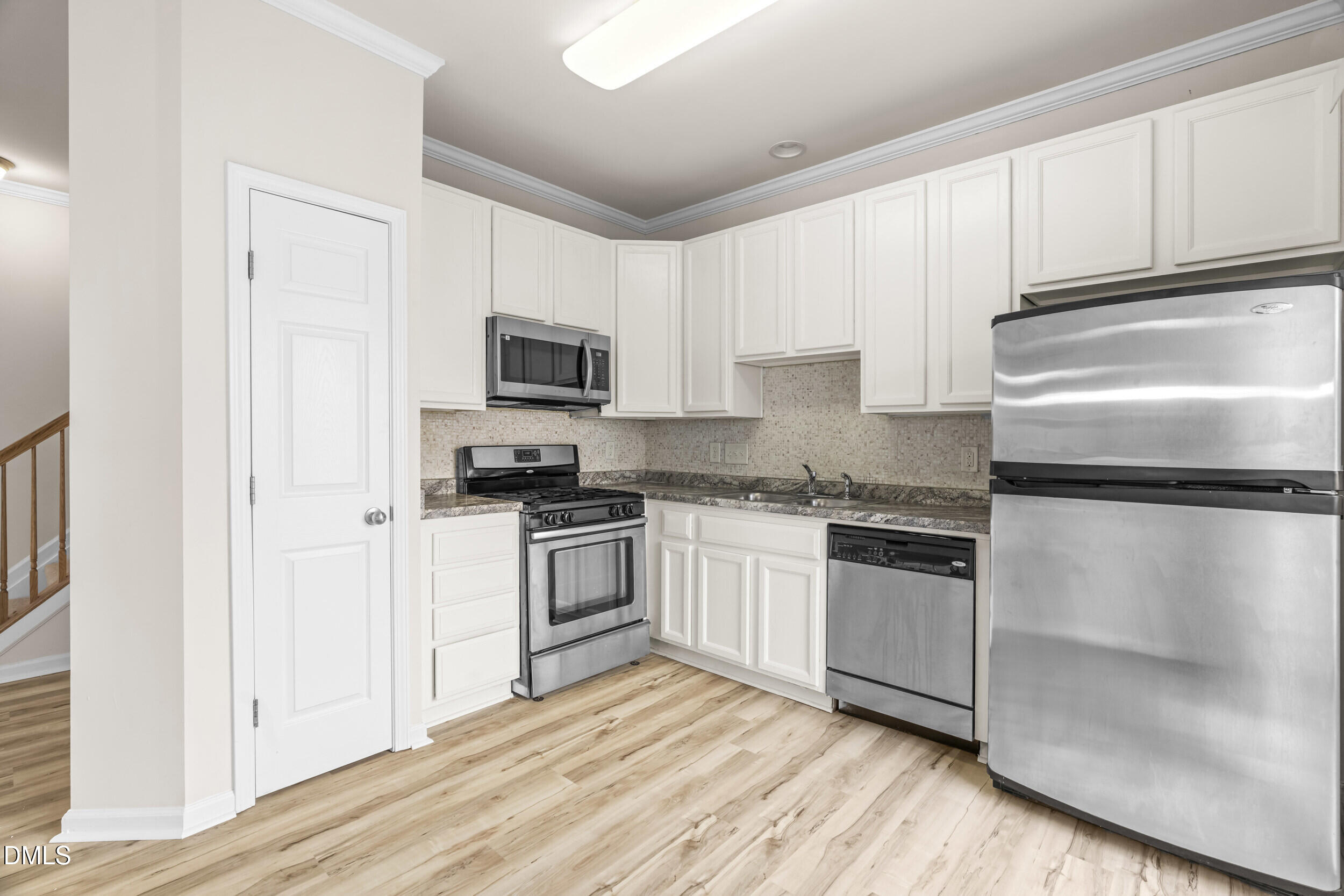 11710 Coppergate Drive, Unit 111 Raleigh, NC 27614 - Photo 7 of 31 a kitchen with granite countertop a refrigerator stove and microwave