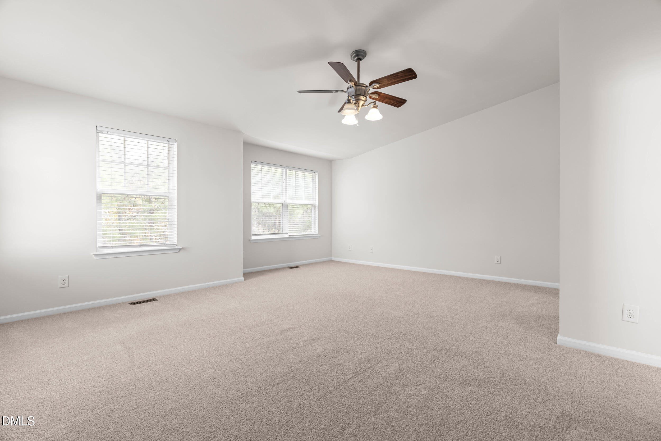 11710 Coppergate Drive, Unit 111 Raleigh, NC 27614 - Photo 11 of 31 an empty room with windows and fan