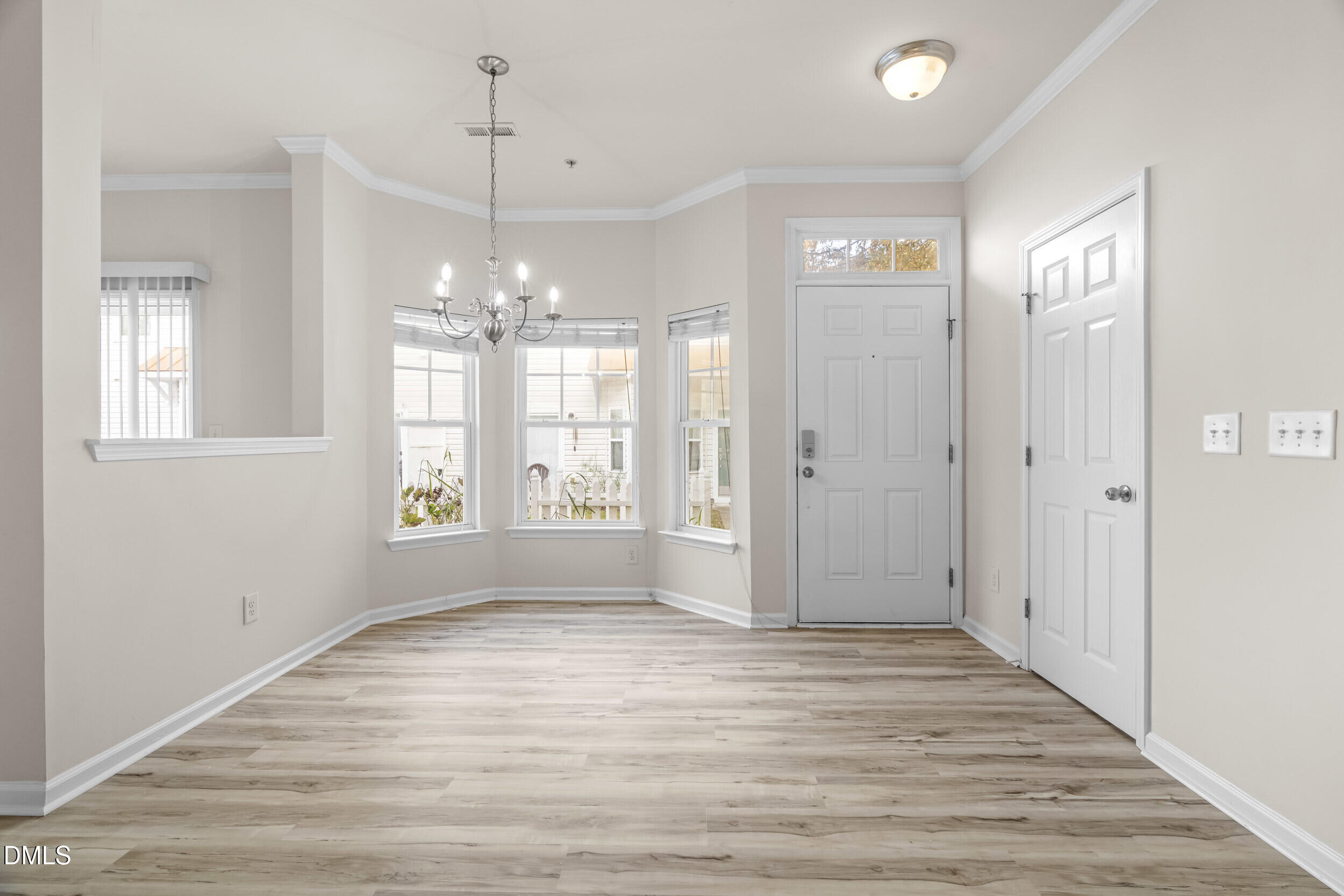 11710 Coppergate Drive, Unit 111 Raleigh, NC 27614 - Photo 2 of 31 a view of an empty room with wooden floor and a window