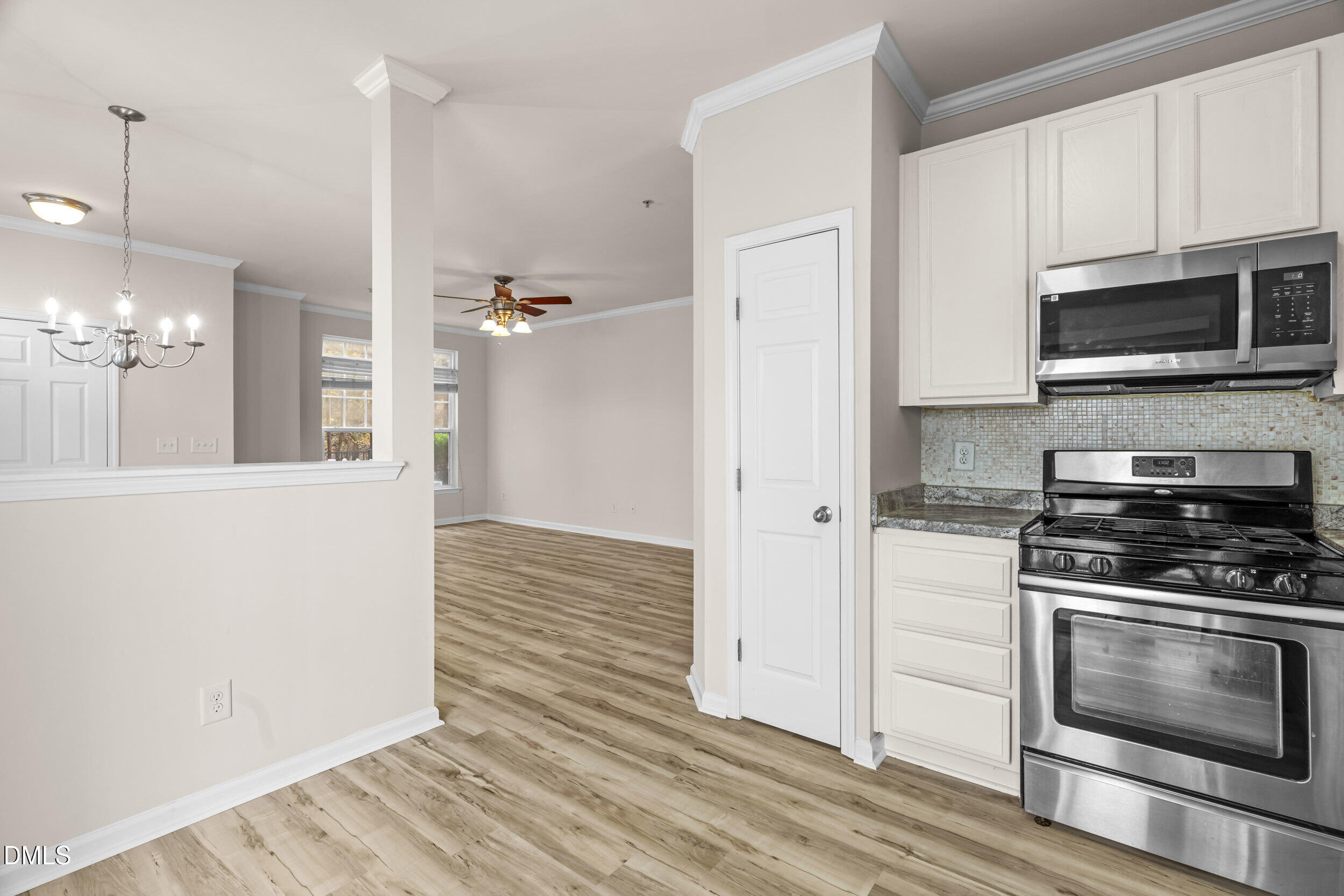 11710 Coppergate Drive, Unit 111 Raleigh, NC 27614 - Photo 5 of 31 a kitchen with stainless steel appliances a stove microwave and a refrigerator